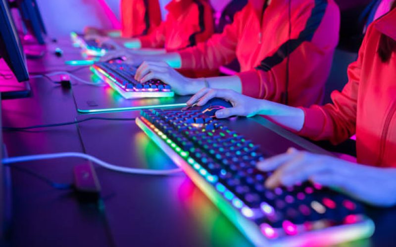close up of pro cyber sport gamer play game with RGB keyboard and mouse
